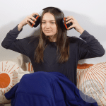 girl putting on her ultimate 10 earmuffs
