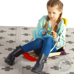 girl in a howdahug seat with a fidget