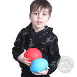 boy holding 2 giant stress balls