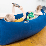 calming corner: 2 kids reading in a sensory canoe