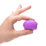 person squishing a teenie neato pup between their fingers