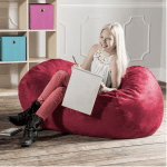 girl doing homework on a lounger beanbag chari