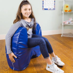 girl sitting in a blue vinyl u-shaped squeeze seat