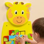 girl sliding the tiles on the giraffe activity wall panel