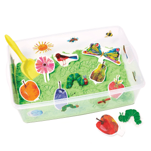 sensory bin with green kinetic sand, characters from the very hungry caterpillar, and a shovel