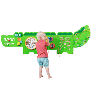 boy playing at a crocodile activity wall panel